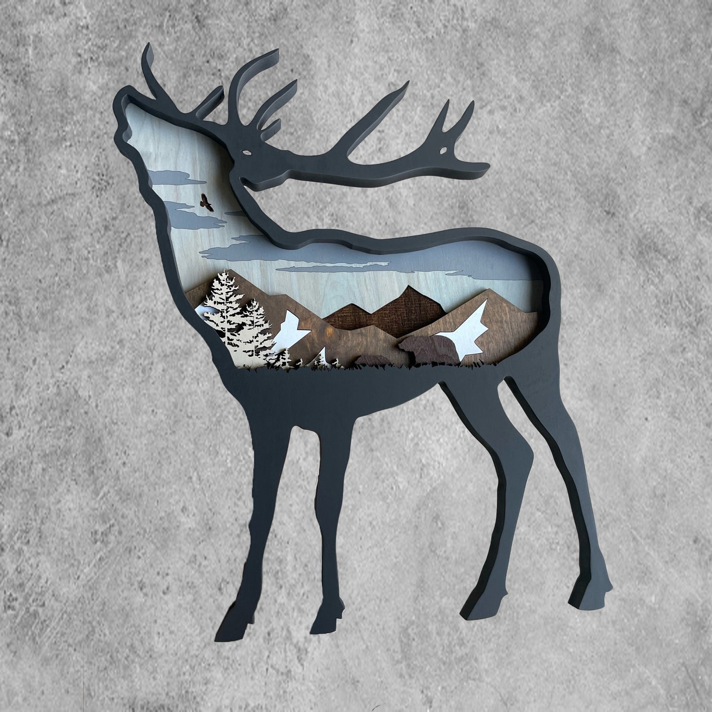 This 3-dimensional elk design features a mountain and bear scenery with an eye-catching black acrylic paint finish.