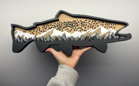 19" Brown Trout wood art with hand for size reference.